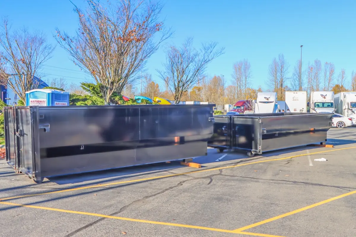 Professional dumpster rental service with roll-off container on residential driveway in North Miami